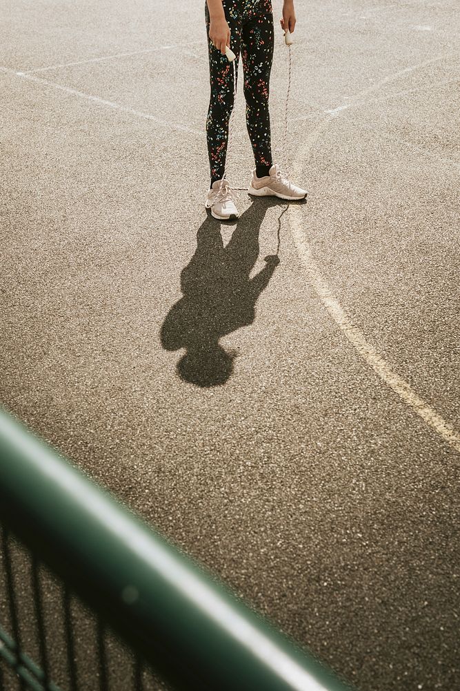 Sport background, girl with a jump rope, summer hobby