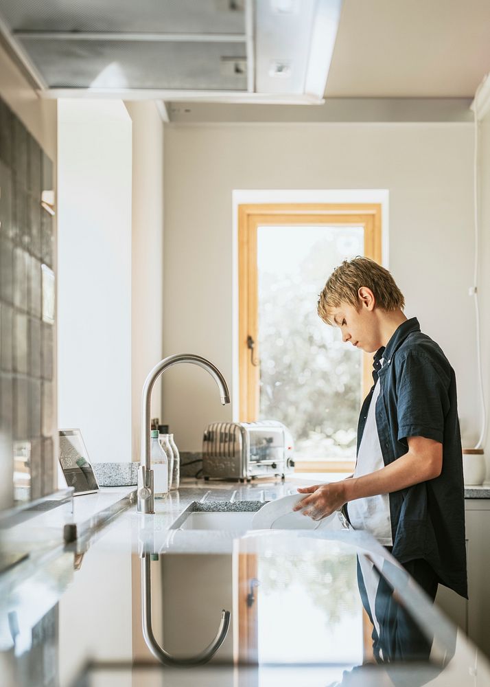 Boy washing dishes, basic house chores