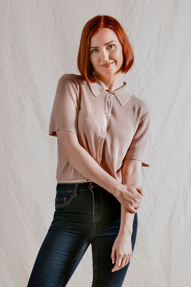 Cheerful woman in brown knitted shirt and jeans