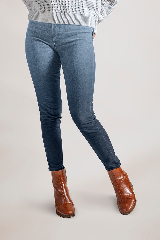 Woman in blue jeans and leather boots, half body