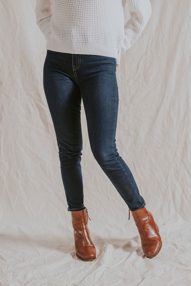 Woman in blue jeans and leather boots, half body autumn fashion