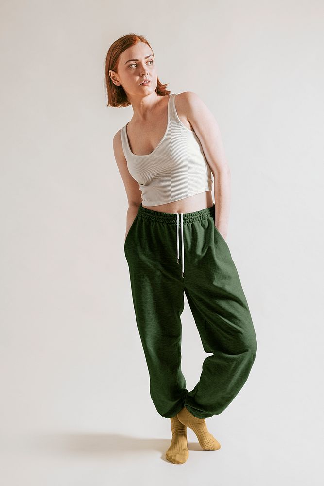 Woman in sleepwear, beige tank top and with green pants