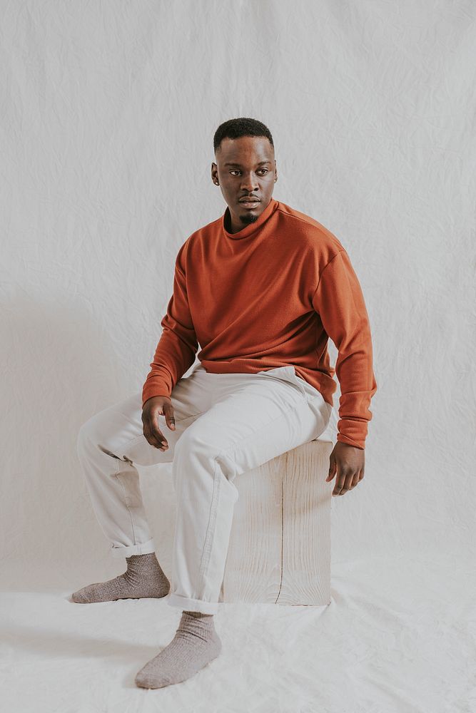 Man in orange long sleeve and beige pants, autumn apparel fashion design