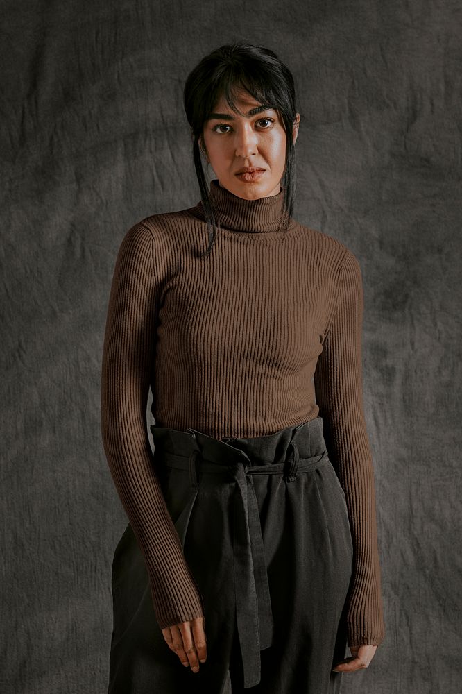 Indian woman wearing brown turtleneck sweater with black pants, autumn apparel fashion design