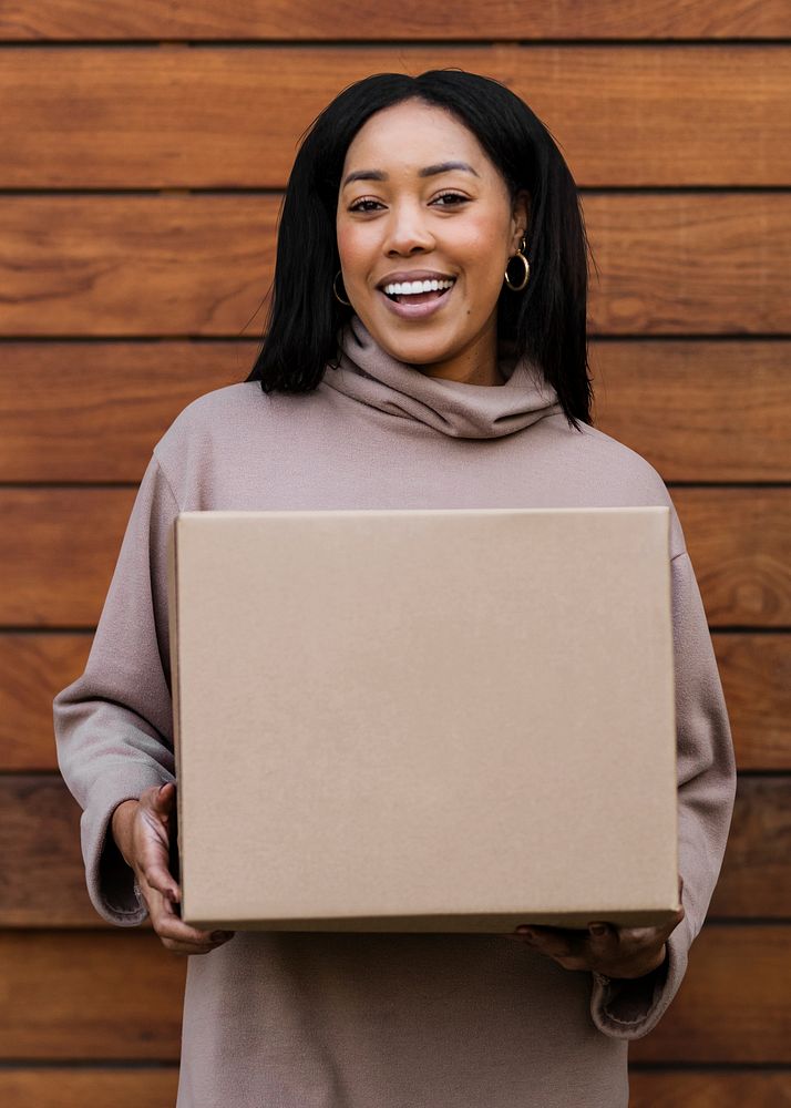 Happy woman receiving delivery package to the front door