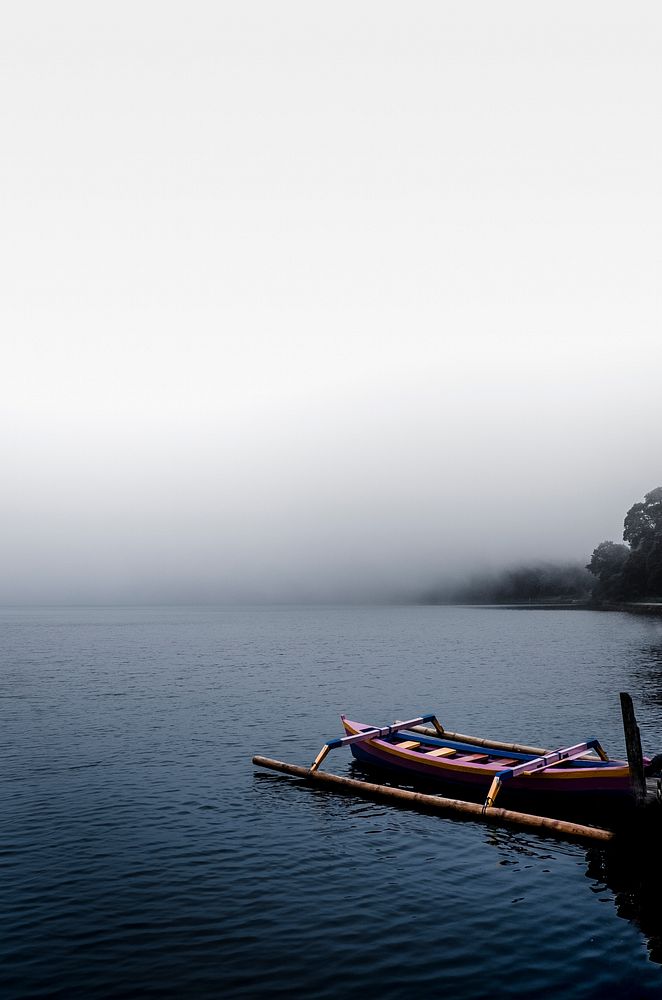 Pink canoe in the mist on a lake in Bali