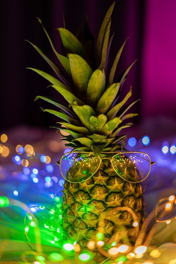 Pineapple with glasses decorated with lights