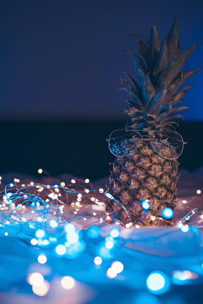 Pineapple with glasses decorated with lights