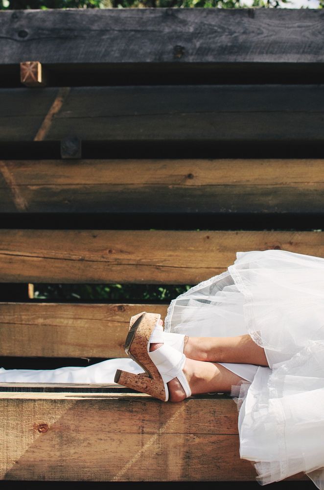 Bride taking a nap on some wood