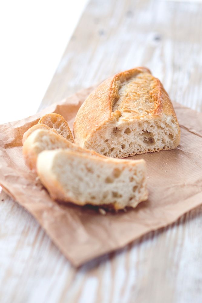 Cut French bread on a brown paper. Visit Kaboompics for more free images.