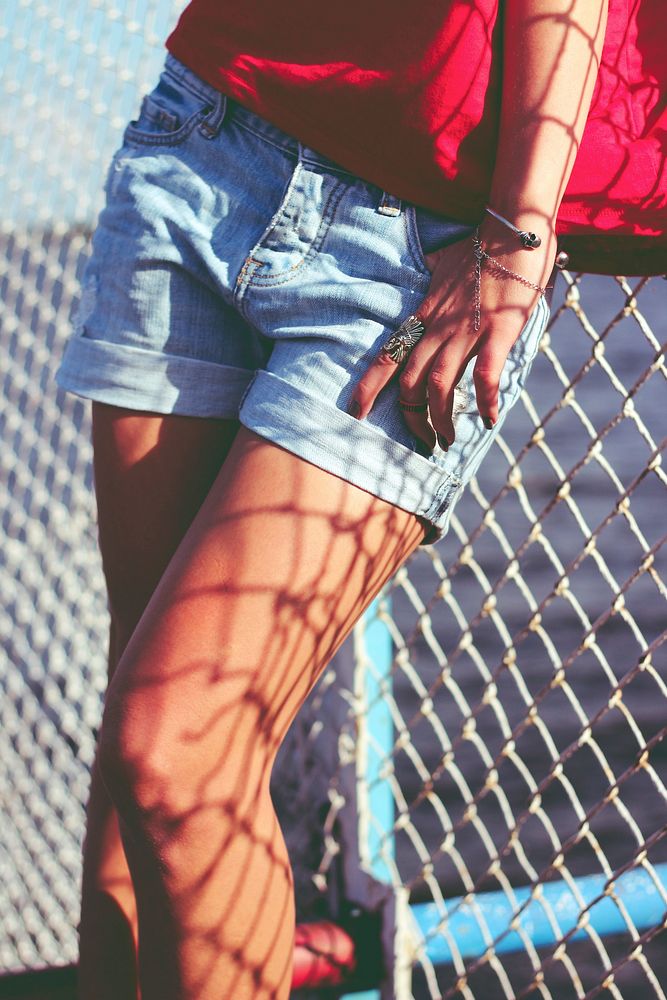 Woman standing by a fence. Visit Kaboompics for more free images.