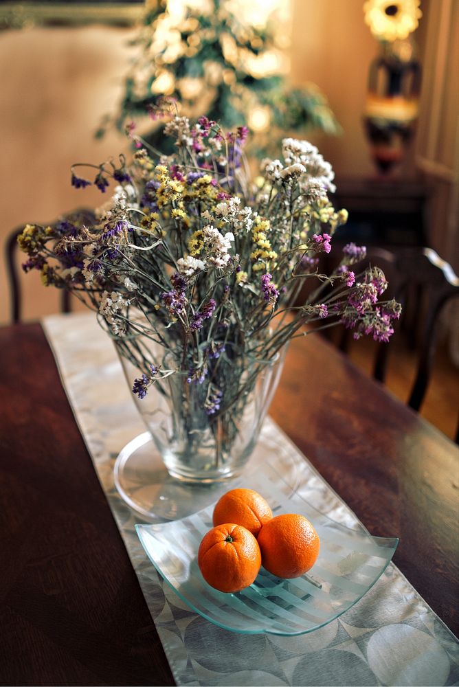 Oranges and flowers on a table. Visit Kaboompics for more free images.