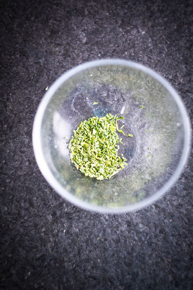 Chopped green herb in a metal bowl