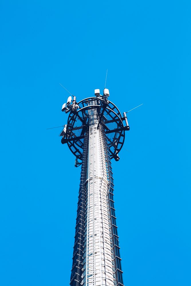 Transmission cellular tower against the blue sky