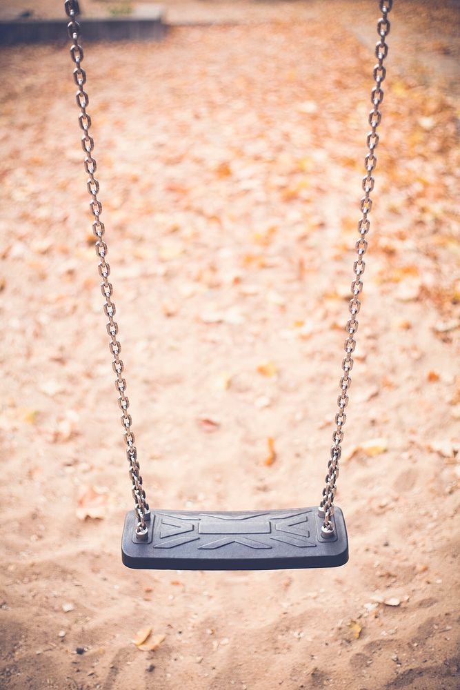 Black plastic swing in a playground