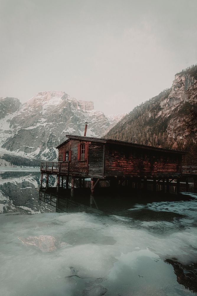 A chalet by Braies lake, Dolomites, South Tyrol, when the sun slowly lifts the mist off