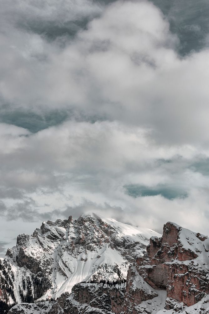 The snow atop the foggy summit of the Dolomites
