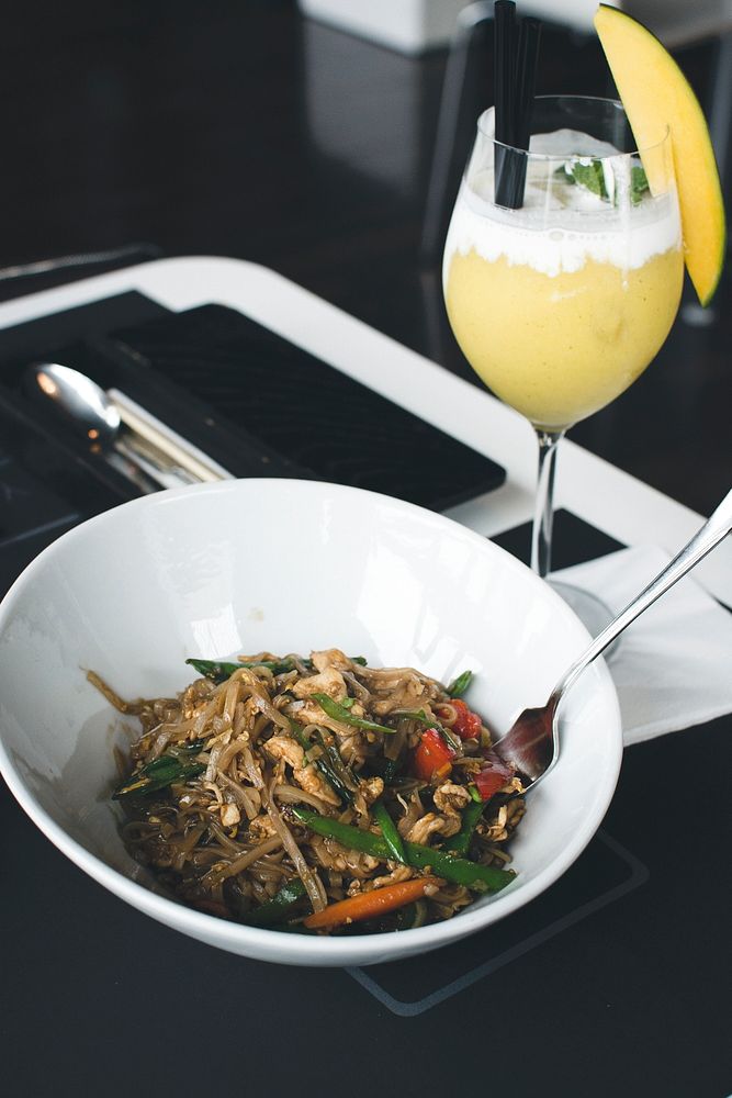 Thai noodle serving with mango smoothie