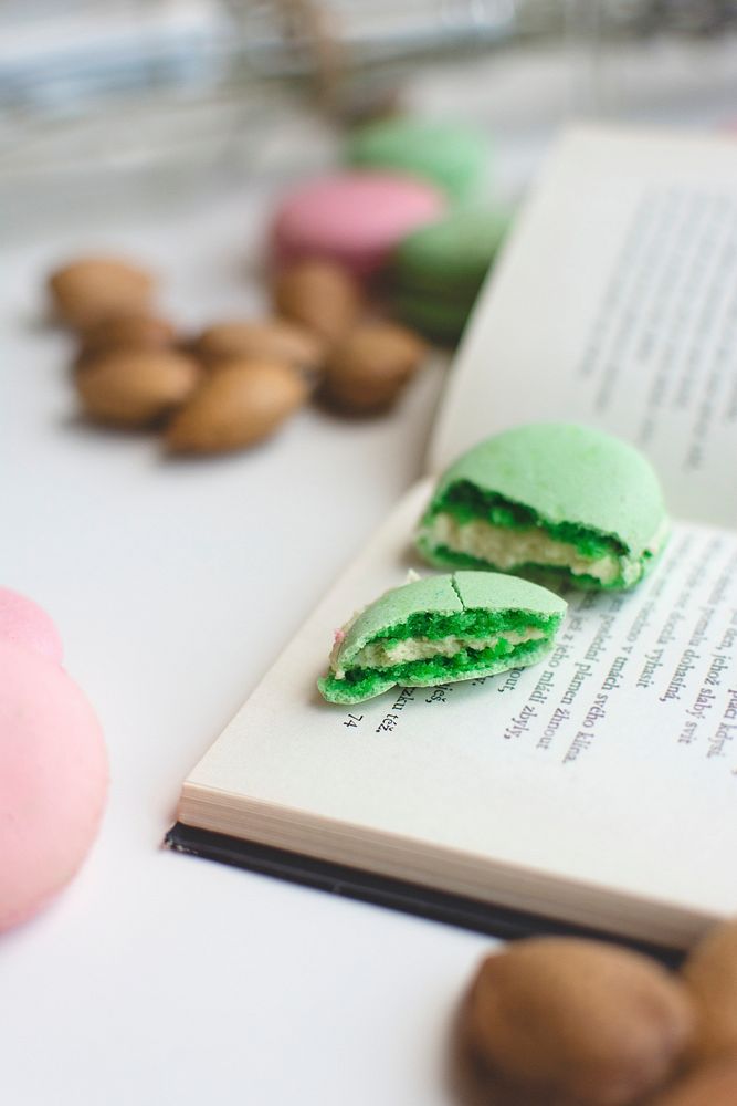 Pink and green macaroons and a book on the table