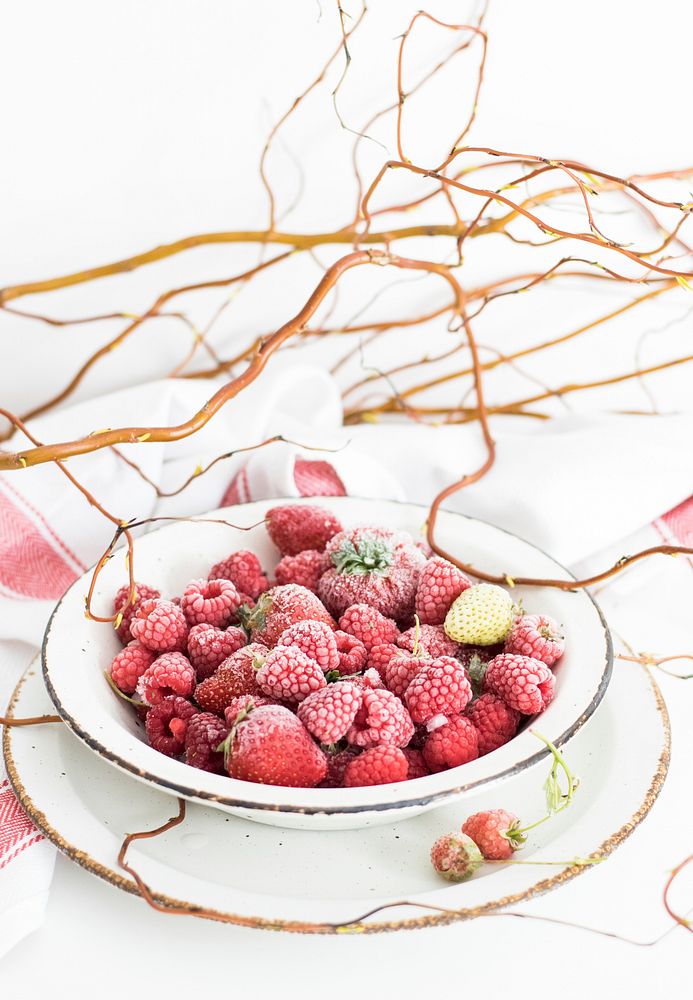Bowl of frozen strawberries and raspberries. Visit Monika Grabkowska to see more of her food photography.