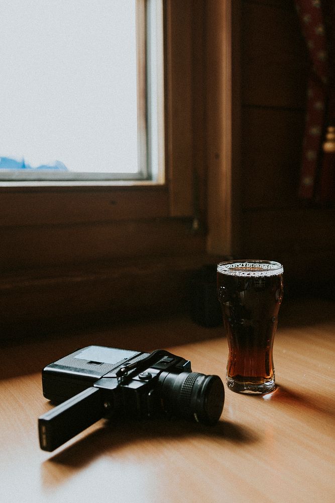 A glass of beer and a retro video camera