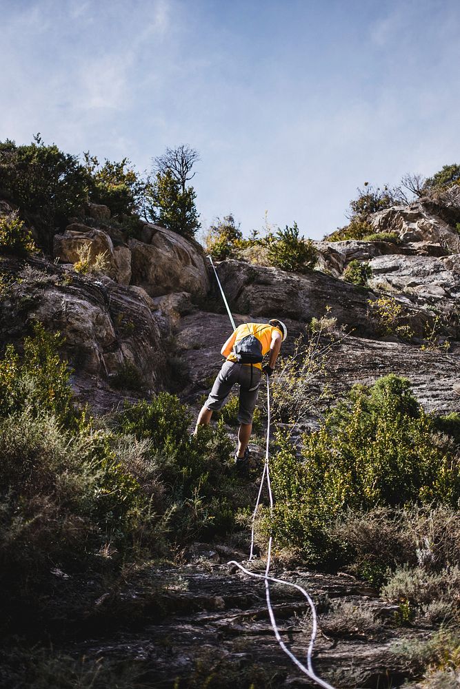 Free person on mountain cliff photo, public domain nature CC0 image.