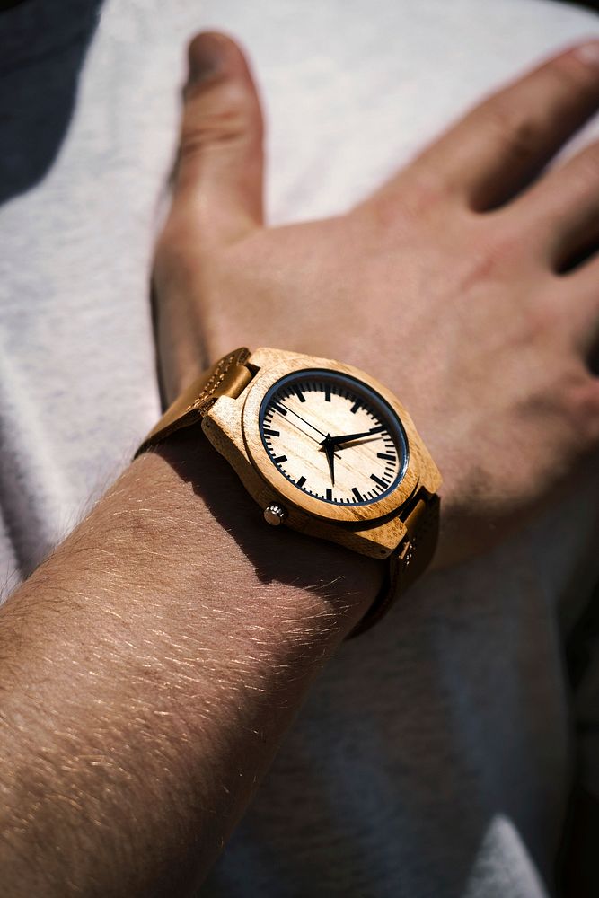 Free closeup of a modern and fashionable wood wrist watch on a man's wrist image, public domain CC0 photo.