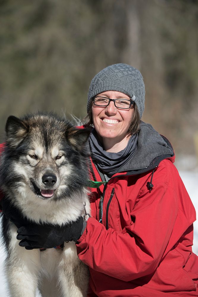 Woman with sled dog. Original public domain image from Flickr