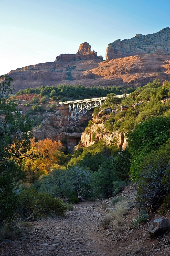The sun highlights the Fall colors in Oak Creek Canyon under Midgley Bridge, as seen from the Huckaby Trail, Coconino…