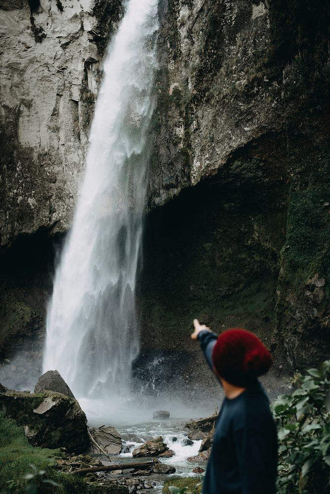Traveler at waterfall. Free public domain CC0 photo.