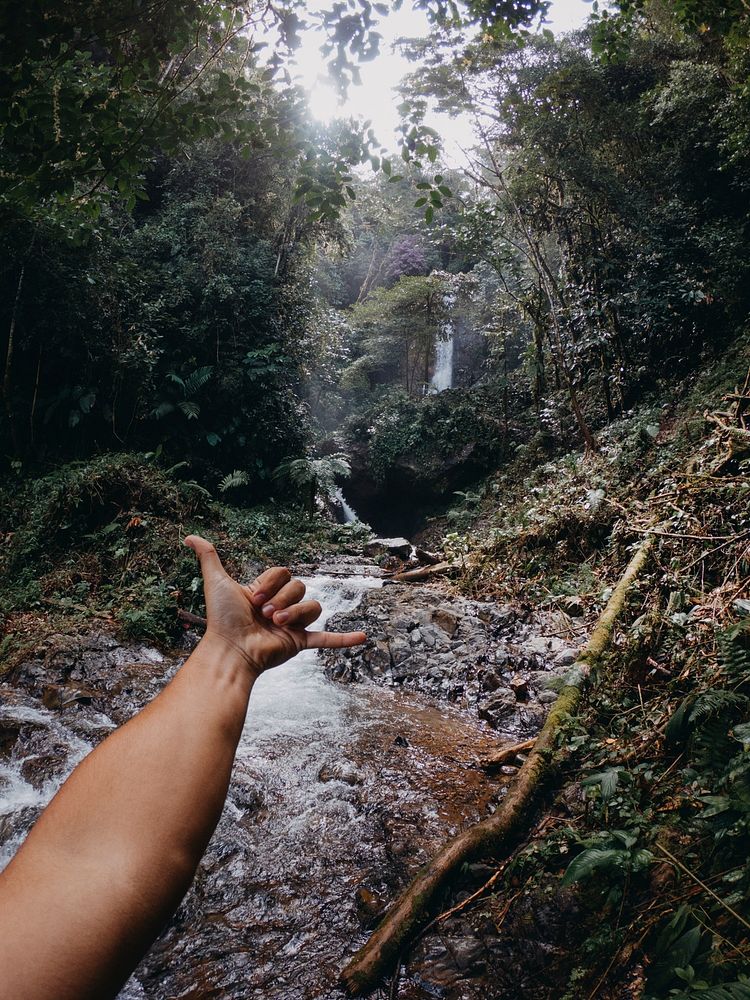 Man at waterfall. Free public domain CC0 photo.