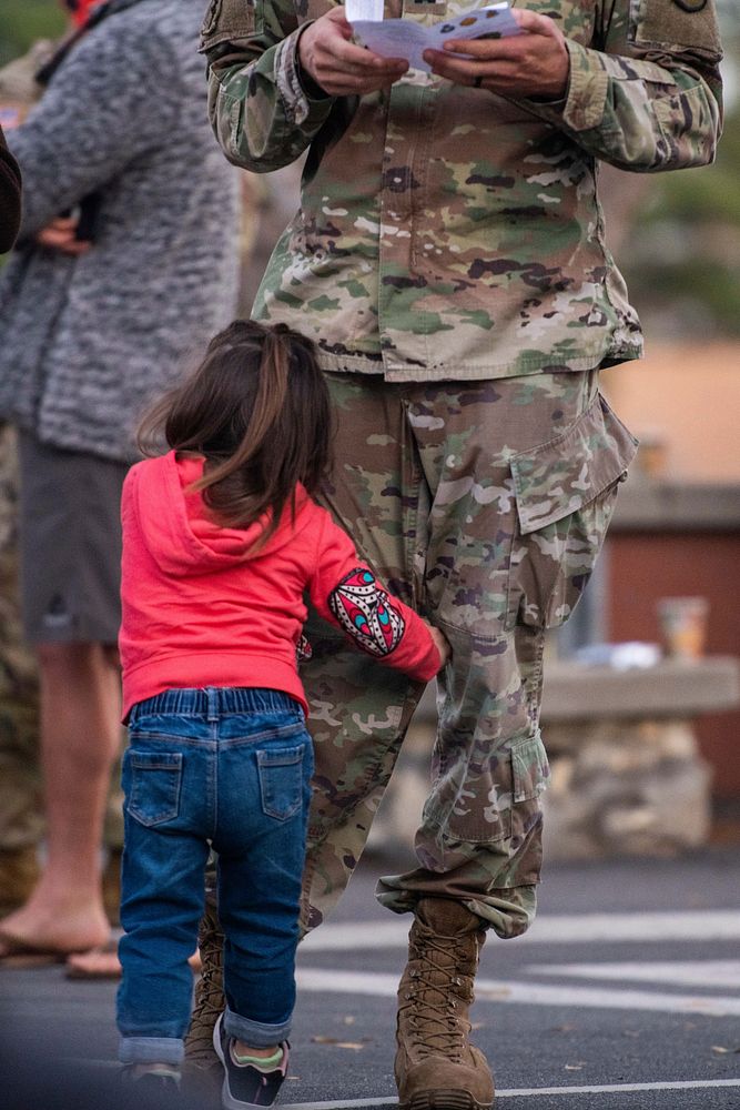 Daughter hugging her U.S. soldier dad. Original public domain image from Flickr