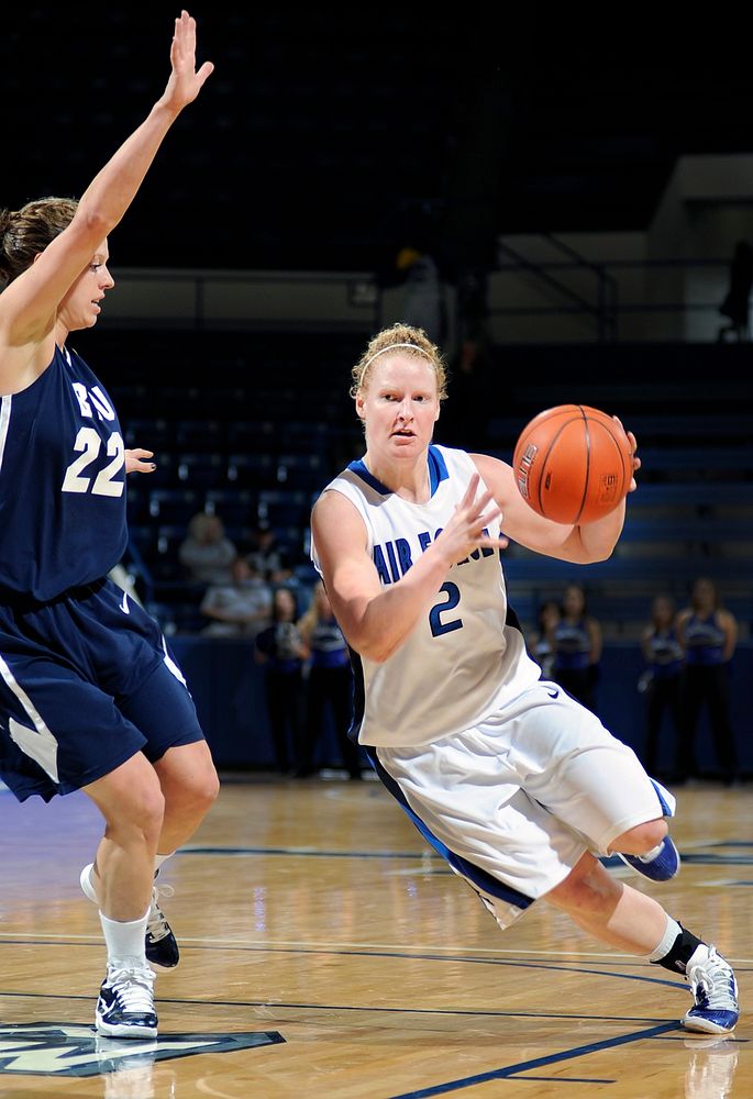U.S. Air Force Academy Falcons sophomore guard Alicia Leipprandt, right, charges past Brigham Young University senior guard…