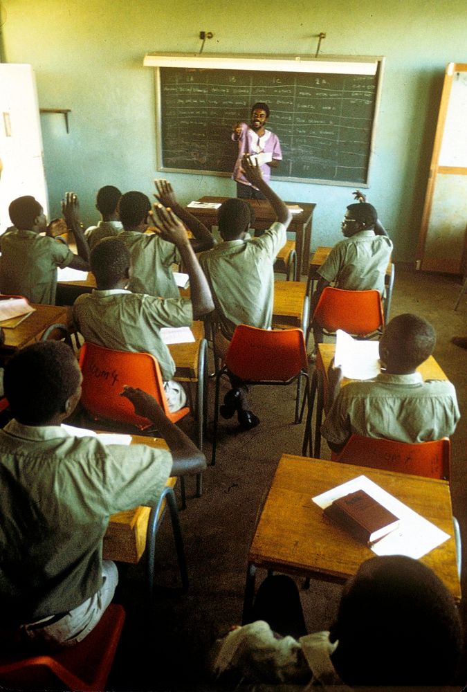 A Peace Corps Volunteer teaches an English class at Kisumu Technical School in Kenya,1979. Original public domain image from…