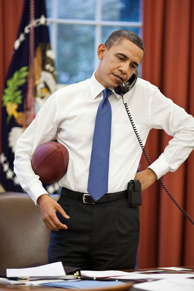 President Barack Obama talks on the phone with House Speaker John Boehner in the Oval Office, April 8, 2011.