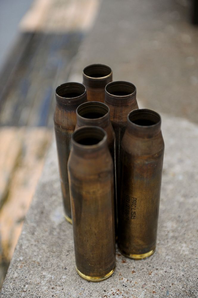 GRAFENWOEHR, Germany -- A cluster of expended 30mm ammunitions sits after being fired by a Warrior Infantry Fighting Vehicle…