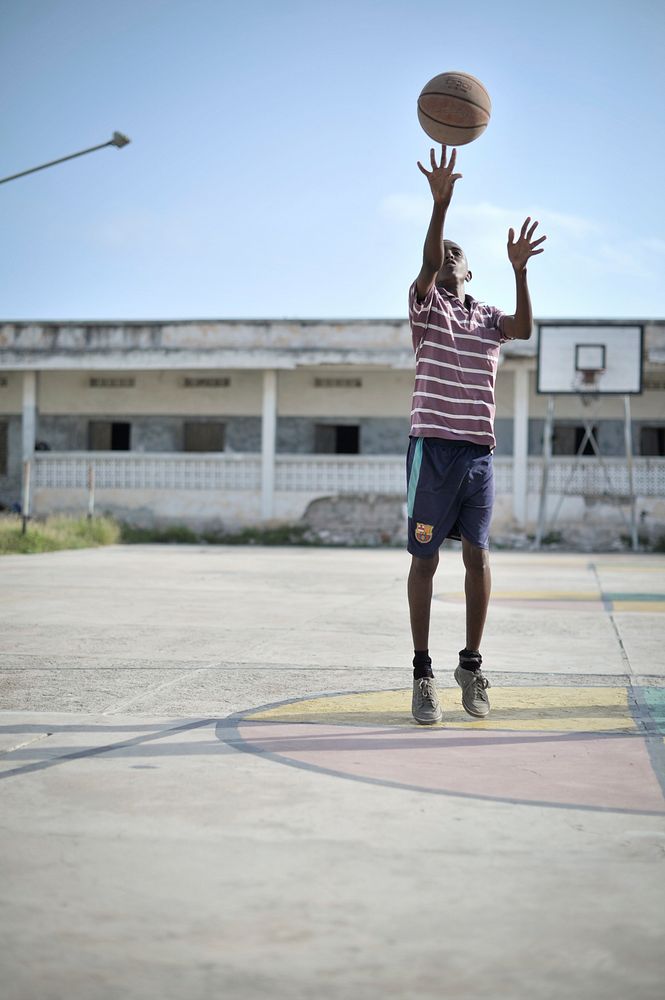 A boy practices his shot on a basketball court in Mogadishu, Somalia, on June 6. Banned under the extremist group, Al…