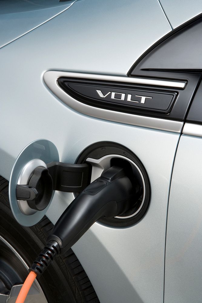 Shown is a close-up of the 2011 chevrolet volt plugged in to charge its battery.( Image courtesy of general motors).…