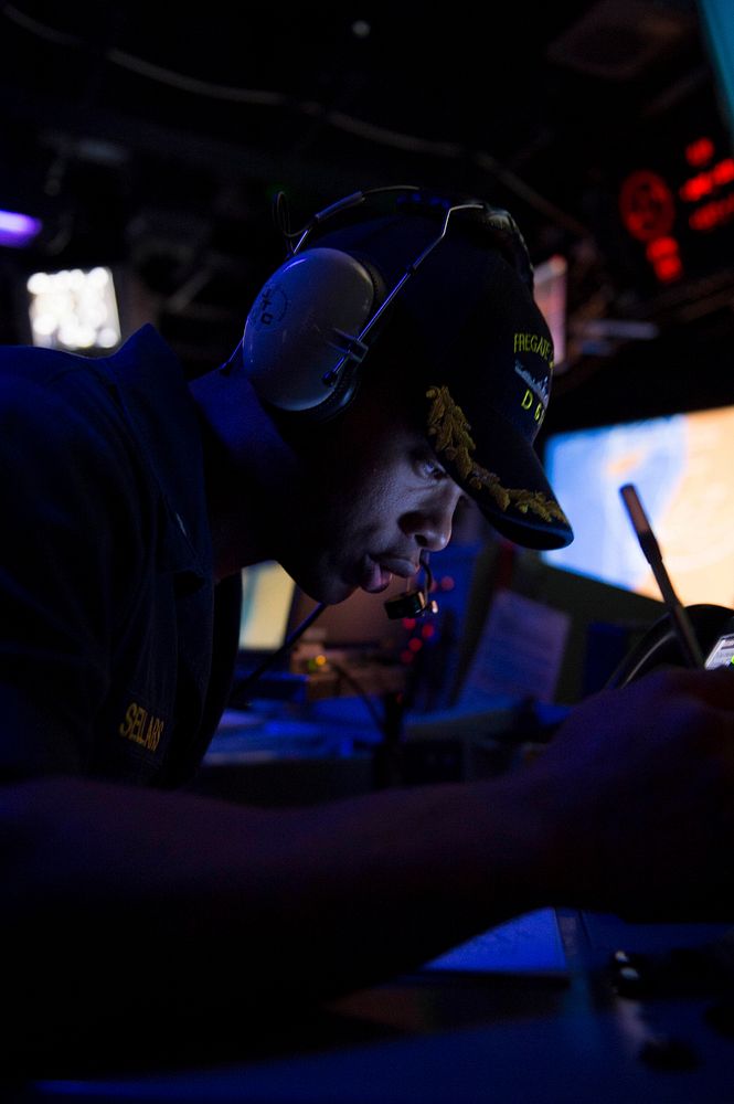 U.S. Navy Lt. j.g. Gerald Sellars stands watch as the ballistic missile defense officer during a ballistic missile defense…