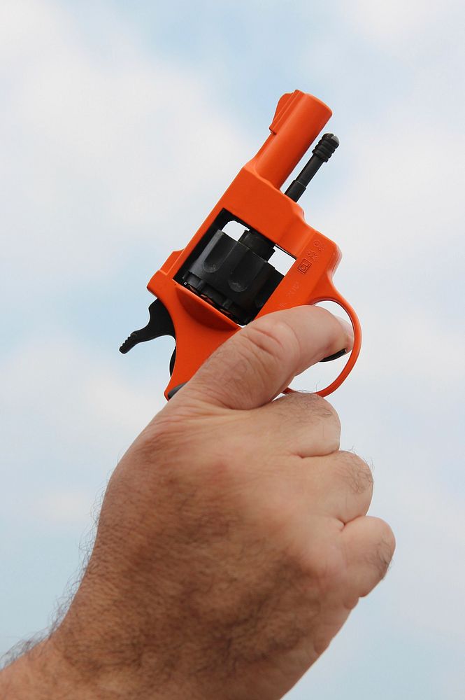 Small orange gun with a clear sky background. Original public domain image from Flickr