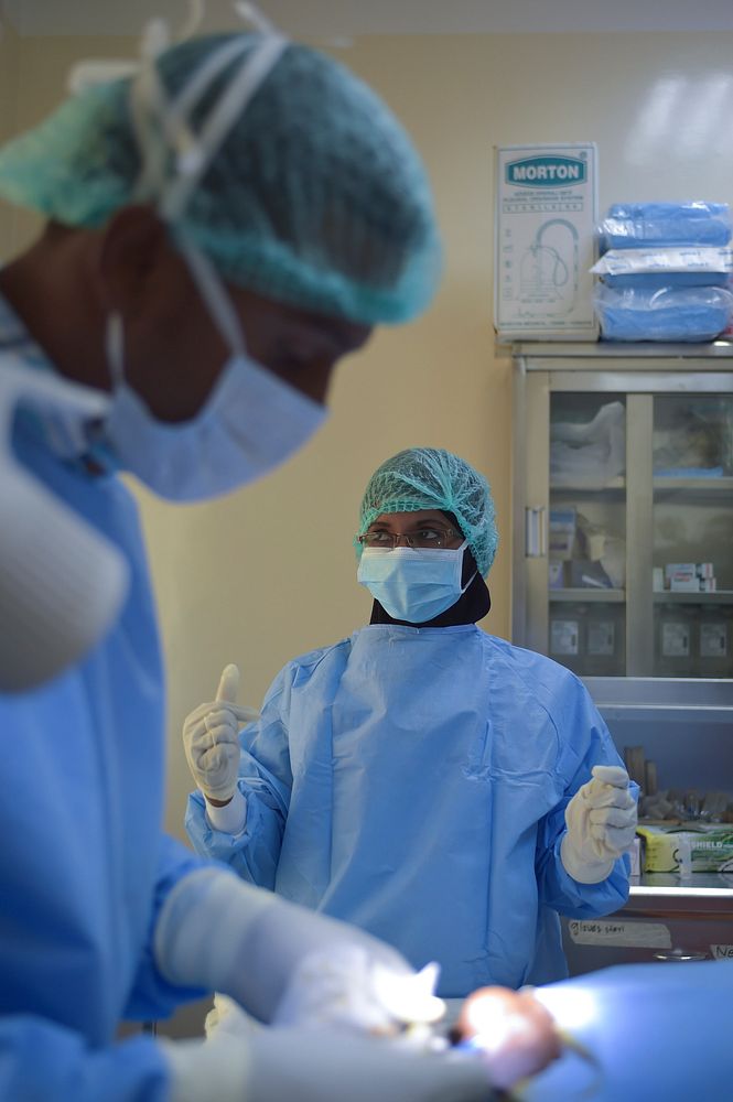 A nurse stands in the operating room of the Sheikh Zayed Bin Sultan Al'Nahya Hospital in Mogadishu, Somalia, while a doctor…