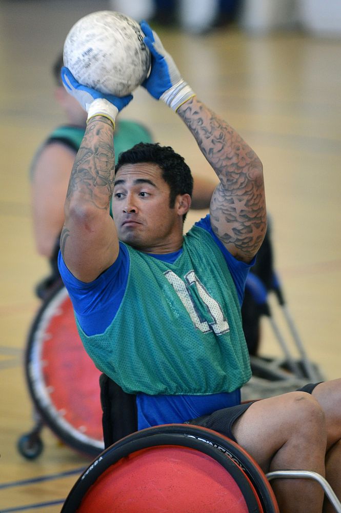 Wounded Warrior Wheelchair Rugby player passes the ball during tournament play.