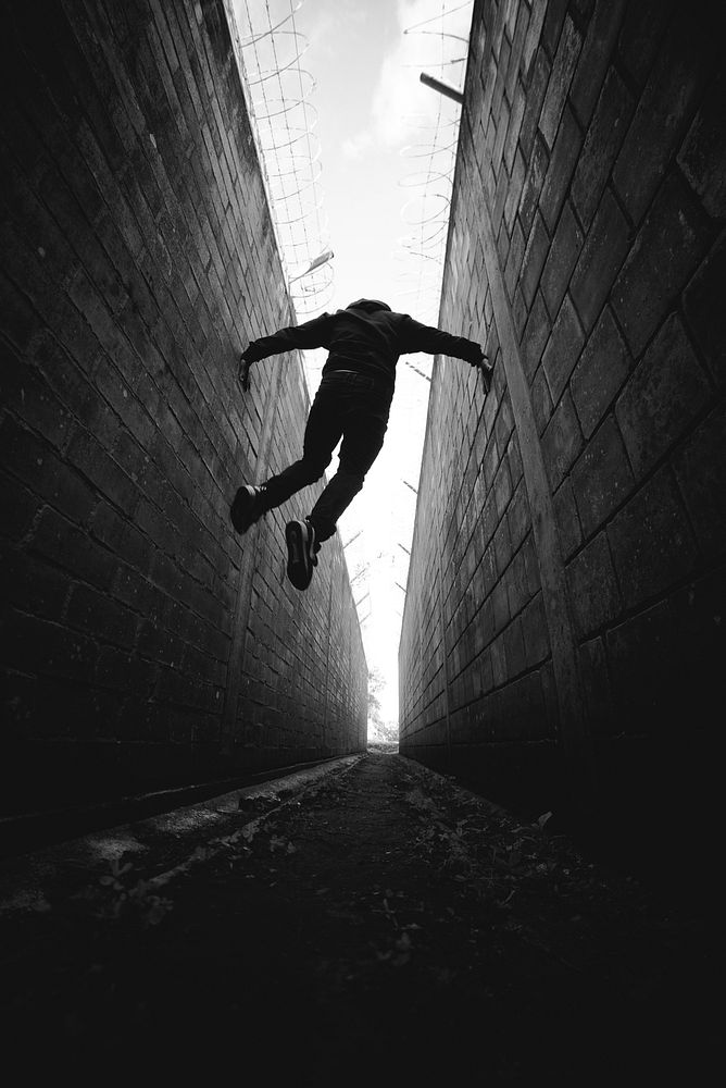 Man jumping in alley. Free public domain CC0 photo.