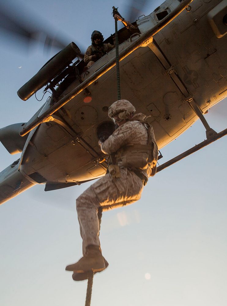 Mediterranean Sea. A Marine assigned to Battalion Landing Team, 3rd Battalion, 6th Marines, descends from a UH-1Y Huey…