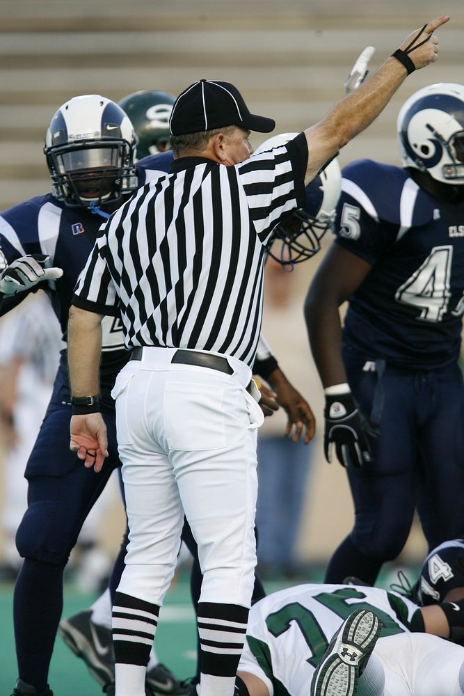 American football referee first down signal during game, location down, May 22, 2016. View public domain image source here