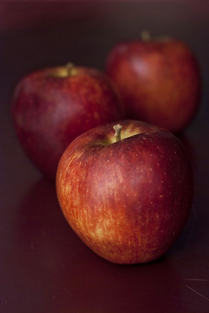 Closeup on apples on wooden table. Free public domain CC0 photo.