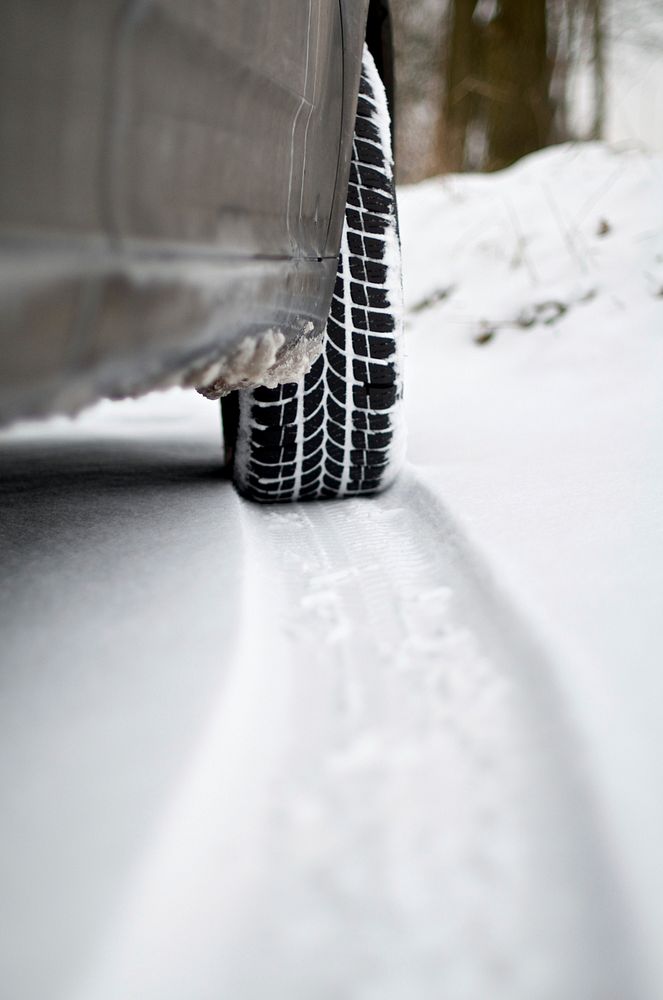 Closeup on car tire tracks on snow. Free public domain CC0 image.