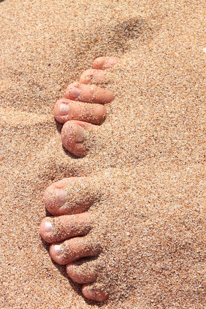 Feet in the sand, background photo. Free public domain CC0 image.