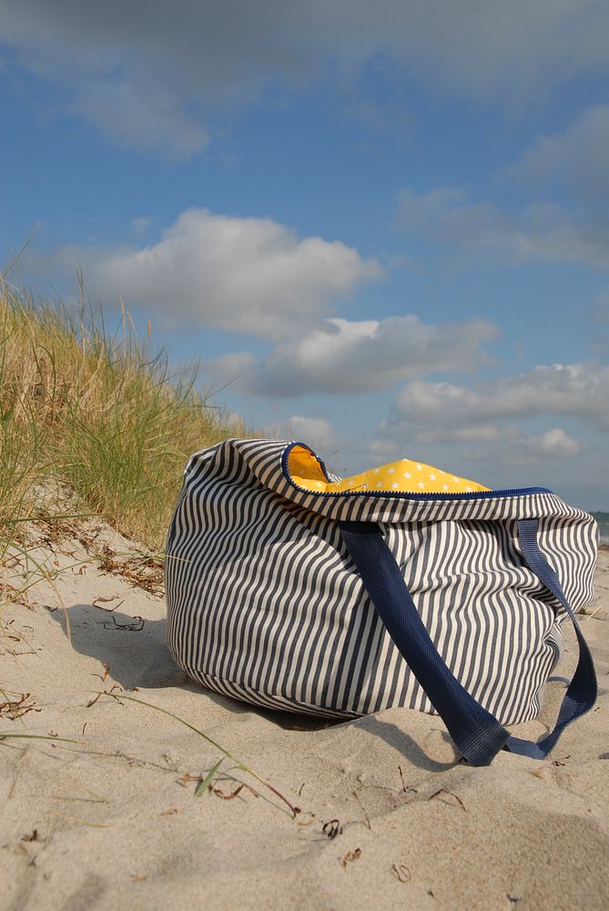 Bag on beach sand. Free public domain CC0 image.