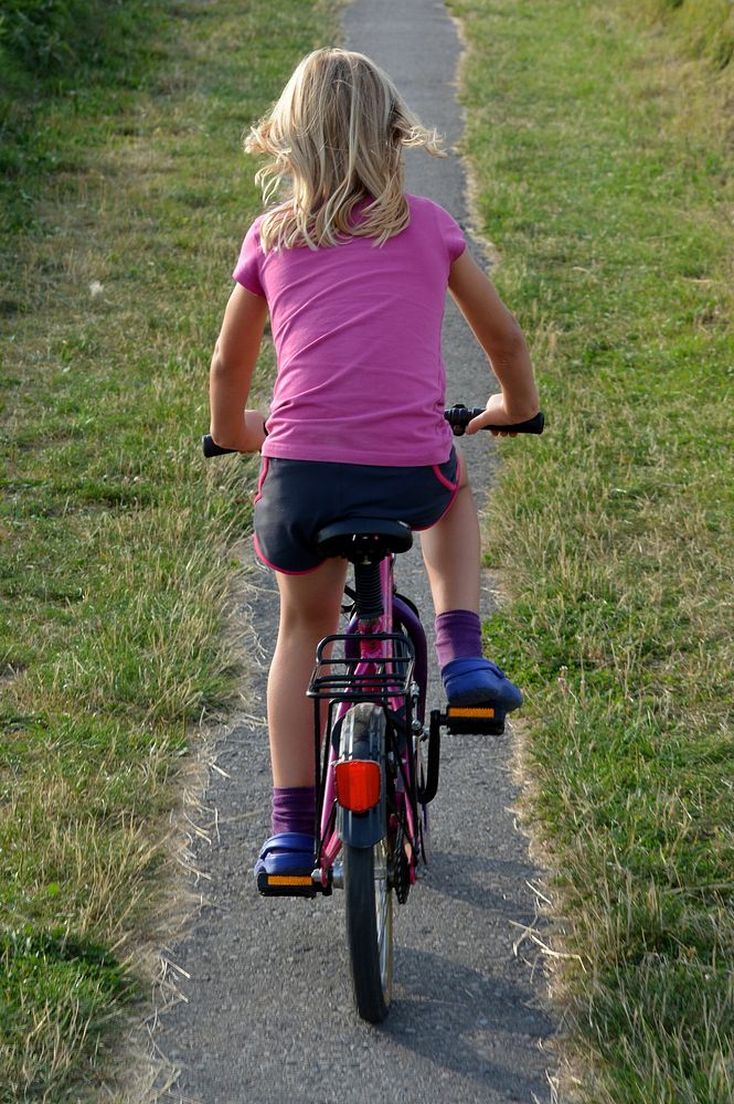 Girl biking. Free public domain CC0 photo.